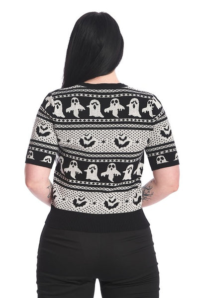 model wearing cotton pullover short sleeve sweater with round ribbed neckline and black & white knit-in Fair Isle style horizontal pattern of ghosts and bats. Shown from back