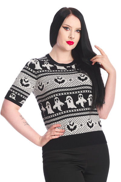 model wearing cotton pullover short sleeve sweater with round ribbed neckline and black & white knit-in Fair Isle style horizontal pattern of ghosts and bats. Shown from front in close up