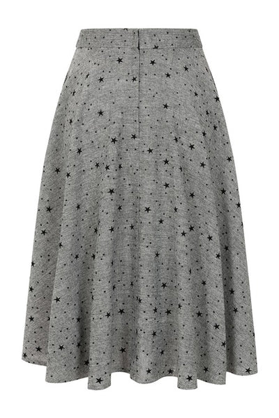 grey tweed high waisted swing skirt with all over flocked black star pattern, fabric covered button detail at waistband, and pockets. Shown from back