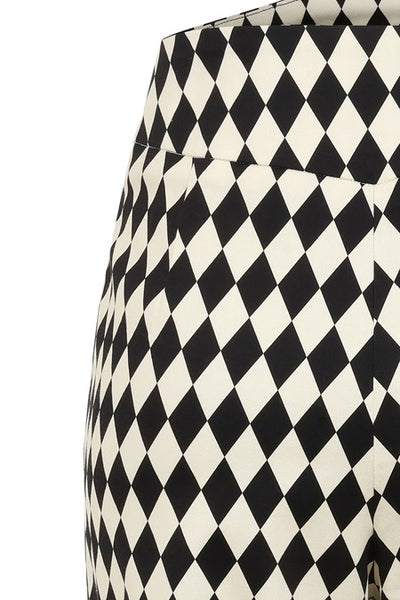 Black and white harlequin patterned stretch cotton sateen cigarette style pants with a high yoke style waistband. Shown from front on mannequin In close up of hip