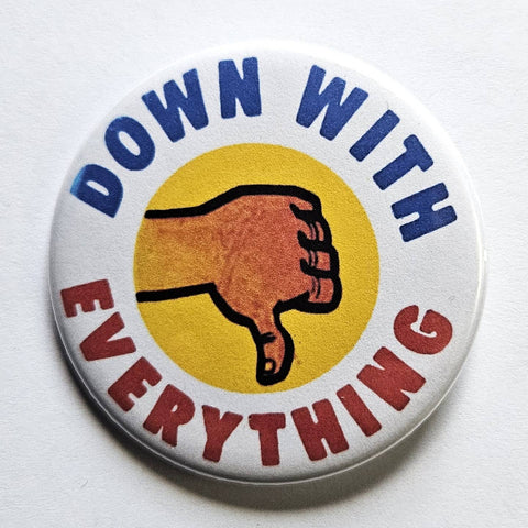 1.25" round pinback button with white background and cartoon thumbs down with caption "DOWN WITH EVERYTHING" curved around in blue and red