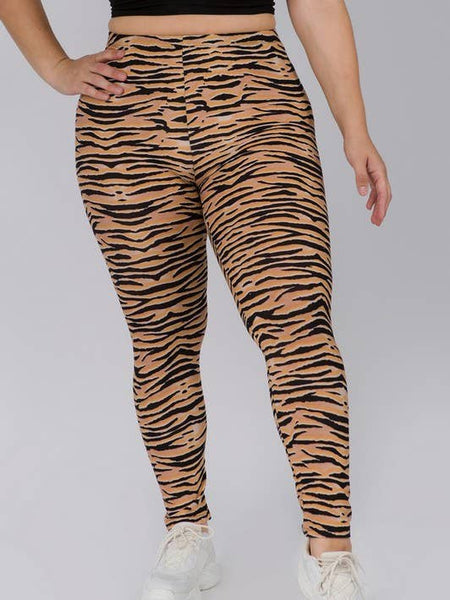 plus size model wearing high-waisted, full-length brushed fiber knit leggings with a black and orange tiger stripe pattern. Shown from front