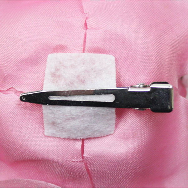 Hair clip on a pink fabric background