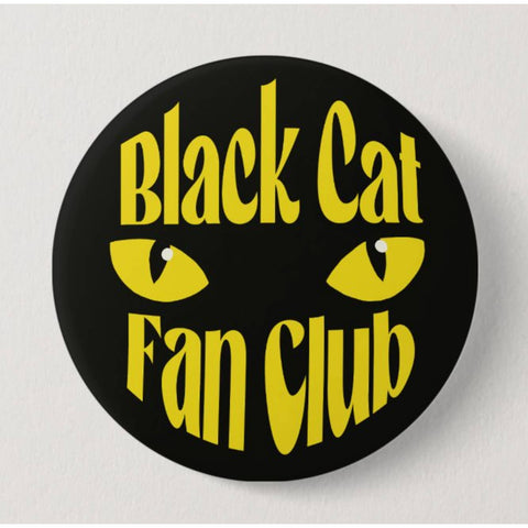 Button badge with 'Black Cat Fan Club' text and yellow cat eyes on a black background