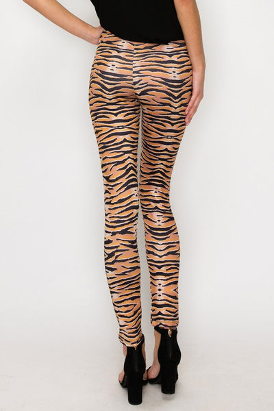 model wearing high-waisted, full-length brushed fiber knit leggings with a black and orange tiger stripe pattern. Shown from back