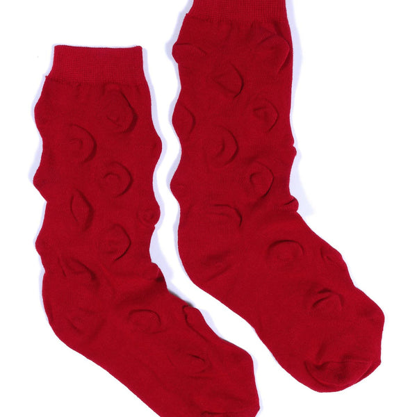 red cotton blend socks knit with short row technique to create triangle "spikes" in the fabric of each sock