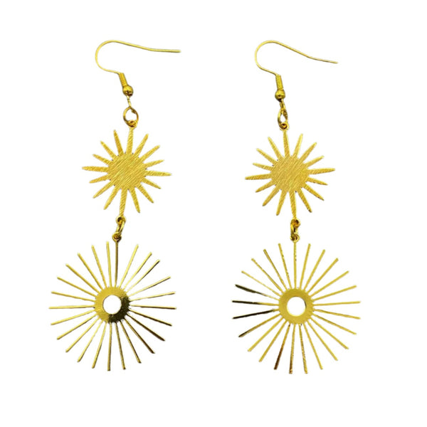 A pair of gold metal dangle earrings with two large starbursts -one smaller with solid middle and larger with hollow middle
