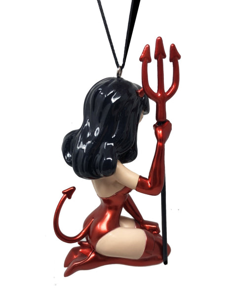 “Devil Girl" painted resin ornament featuring Bettie Page wearing metallic red devil costume with red thigh high boots, devil ears and tail, and holding a matching red trident. Shown from back