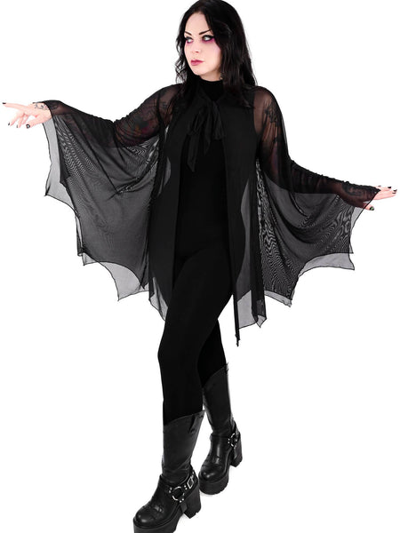 Model wearing a black mesh cape with raw scalloped hemline in the shape of bat wings with sewn in arm holes and a self adjustable front tie. Shown from the front