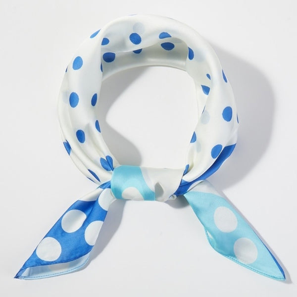 Square scarf with border of two alternating shades of blue with white polka dot pattern and middle white background blue polka dot pattern. Shown tied