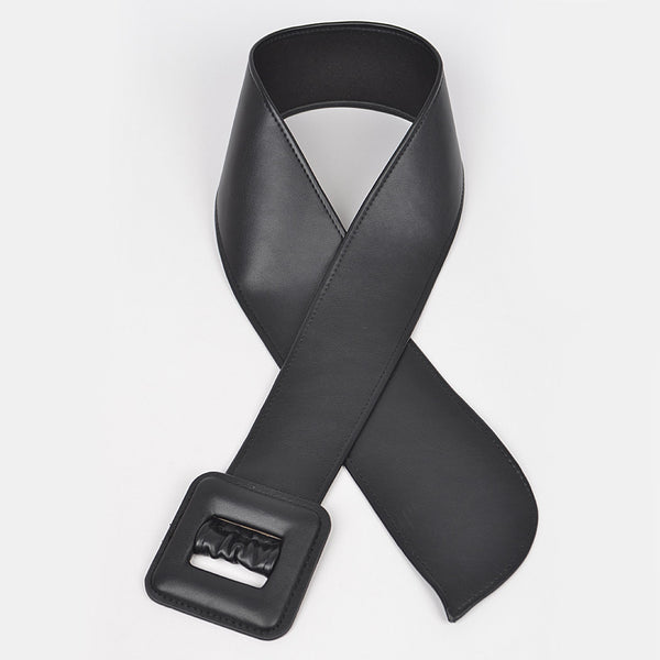 Black matte finish faux leather belt with a large square self buckle flat on a white background