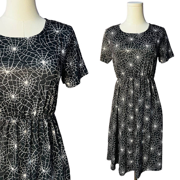 Black t-shirt dress with white spider web pattern on mannequins against a white background