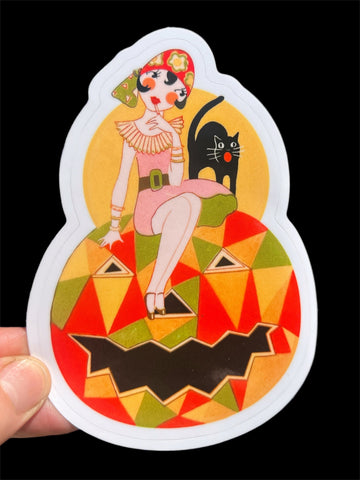 Sticker with a colorful design of a flapper woman, black cat, and geometric painted jack-o’-lantern on a white background