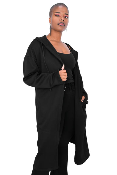 model wearing a black fleece longline open front hoodie sweater with oversized hood with drawstring, long sleeves with thumbholes, and pockets. Shown from front with hood down