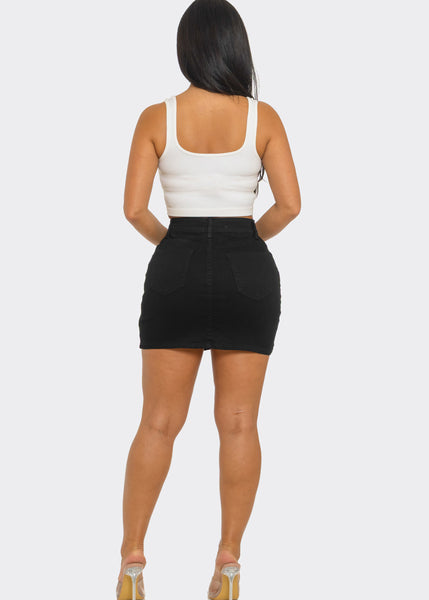 model wearing black denim high-waisted mini skirt with 5 pockets and a zip & button front closure. Shown from back