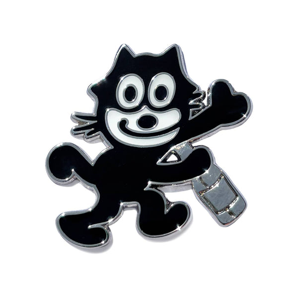 silver metal black and white enamel pin of Felix the Cat smiling and holding a bottle. Shown on white background