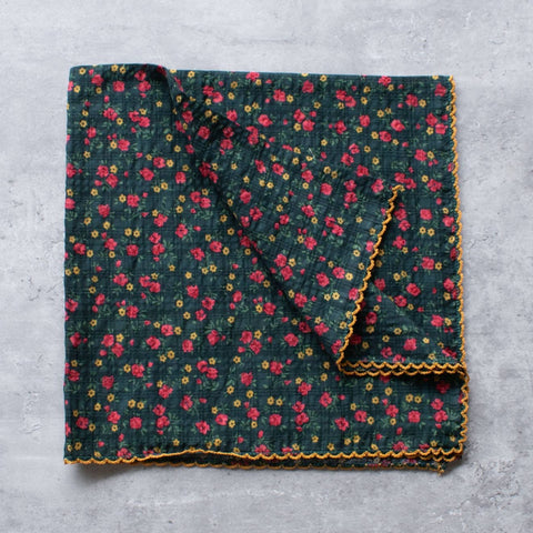 square seersucker cotton scarf in dark green monochromatic plaid with yellow and pink ditsy floral pattern and orange embroidered scalloped border