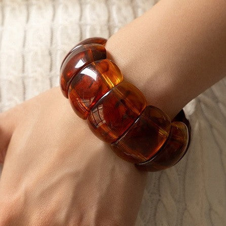 stretch bangle of beveled translucent amber marbled segments on elastic