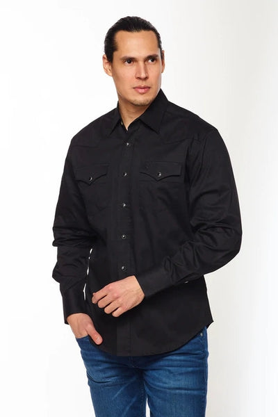 Model wearing a black cotton twill western style button up shirt with black pearl snap closures. Shown from the front