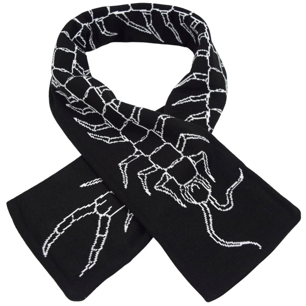 black knit scarf with jacquard knit design of centipede running the length of the scarf. Shown folded over