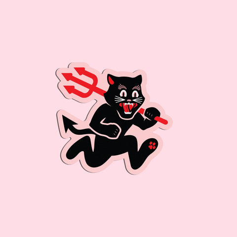 a die cut vinyl sticker of a black cat on a pale pink background running on its hind legs and holding a red pitchfork with its mouth open