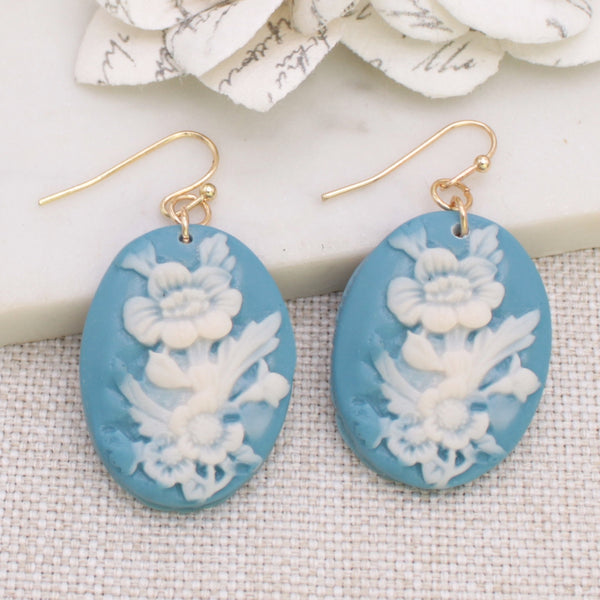 dangle earrings with acrylic floral cameo relief style charms in pale blue and white.