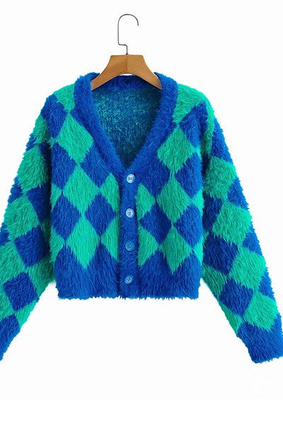 Cropped faux mohair cardigan with dropped shoulders in a bright green and blue harlequin diamond pattern. Shown hanging from the front