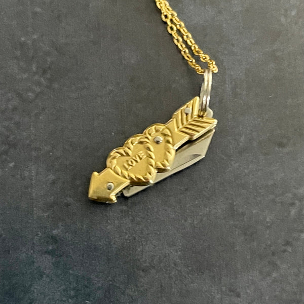 gold tone link chain with heart and arrow design mini pocket knife charm. Charm shown in close up