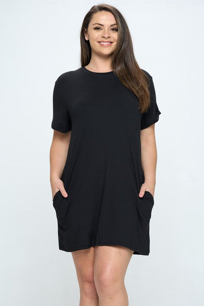 plus model wearing black brushed fiber knit short sleeve knee length dress with side seam pockets. Shown from front