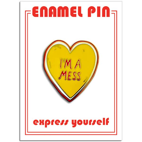 yellow heart with white and red outline and message "I'M A MESS" in red gold metal enamel pin. Shown on packaging card