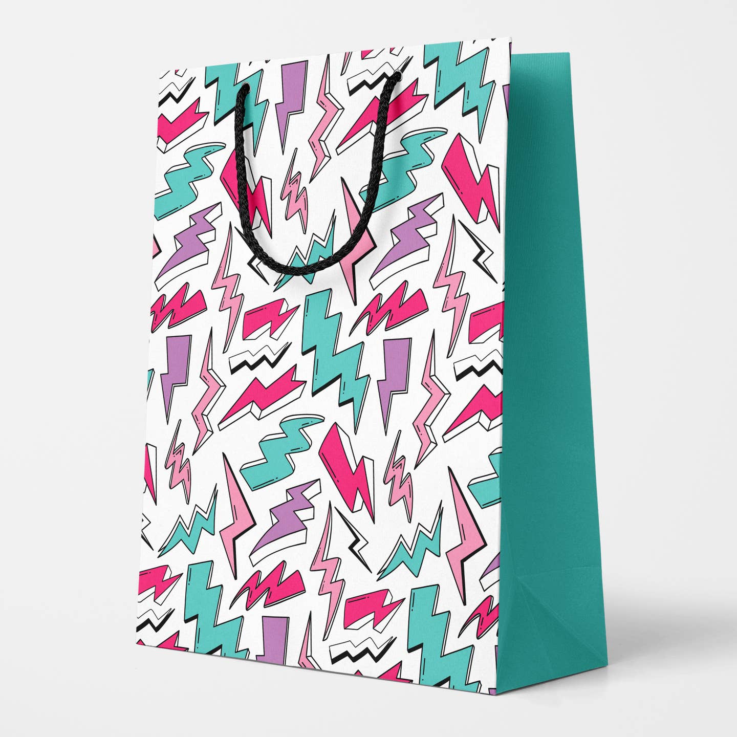 Rectangular gift bag in an all-over teal, purple, pink & white with black outline lightning bolt pattern on a white background. Bag has black polyester rope handle