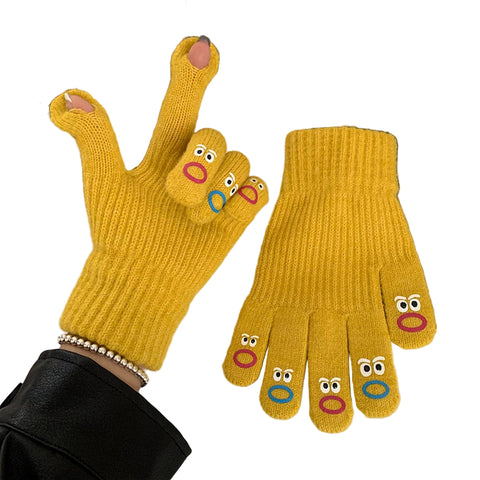 Yellow gloves with cartoon face designs on each fingertip on a white surface