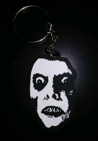 Soft-touch finish black and white rubber keychain of Captain Howdy from The Exorcist 