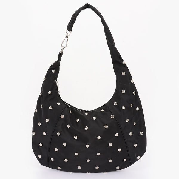black nylon slouchy shoulder bag with silver flat round stud detail, zip closure, and asymmetrical metal clasp detail at shoulder strap. Shown from side