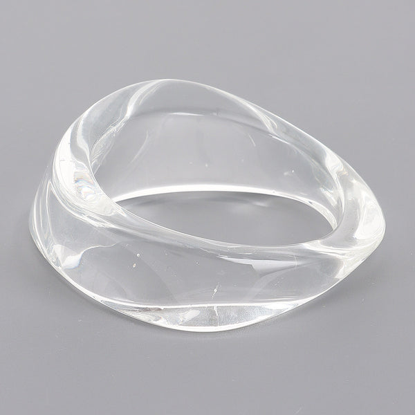 wide asymmetrical clear resin bangle shown flat