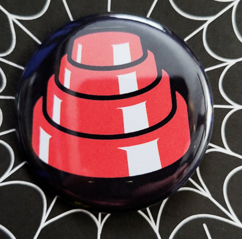 1.25” pinback button with red and white illustration of Devo energy dome hat on black background 