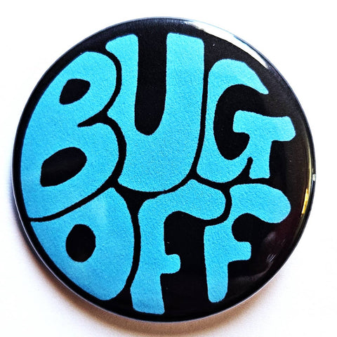 1.25” round pinback button with black background and groovy 60s/70s style bubble lettering in bright blue with message “BUG OFF”
