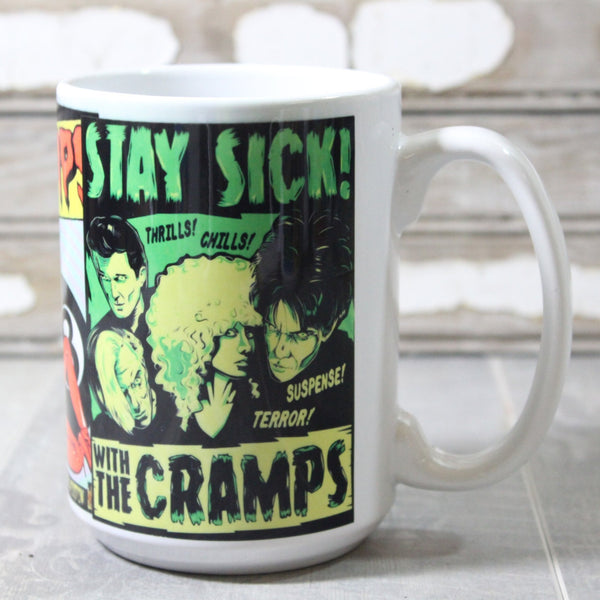 White ceramic mug with neon illustration of Cramps show posters- pictured is “Stay Sick” illustration of band