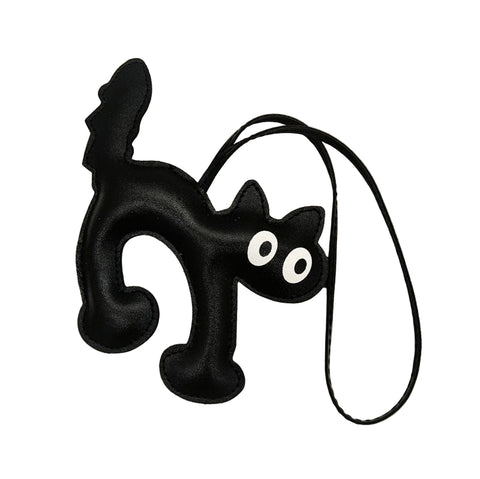 Black cat-shaped faux leather bag charm with printed white eyes and matching 7” cord