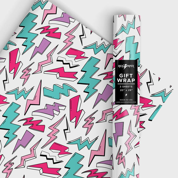 a roll of matte finish gift wrap in an all-over teal, purple, pink & white with black outline lightning bolt pattern on a white background. Shown in a roll and flat