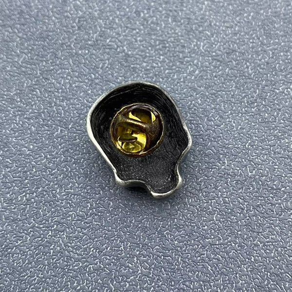 silver metal burnished finish skull brooch. Shown from back