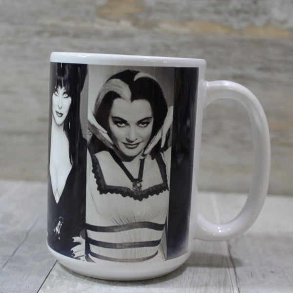 white ceramic mug with a printed black and white collage of the “First Ladies of Goth,” showing view featuring Cassandra Peterson as Elvira and Yvonne De Carlo as Lily Munster