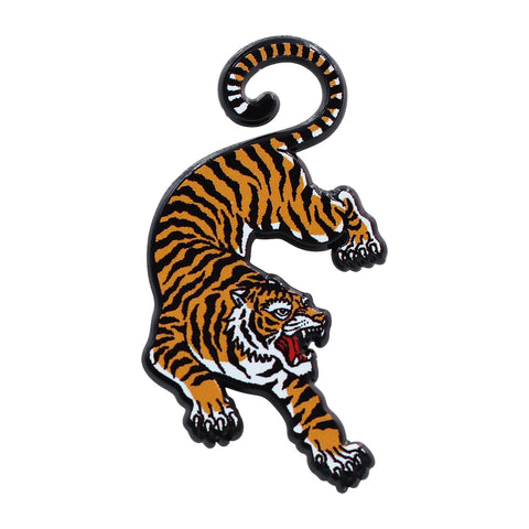 Black enameled pin of an orange and black tiger snarling with its tail curled