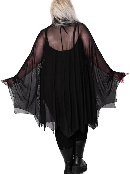 Plus size model wearing a black mesh cape with raw scalloped hemline in the shape of bat wings with sewn in arm holes and a self adjustable front tie. Shown from the back