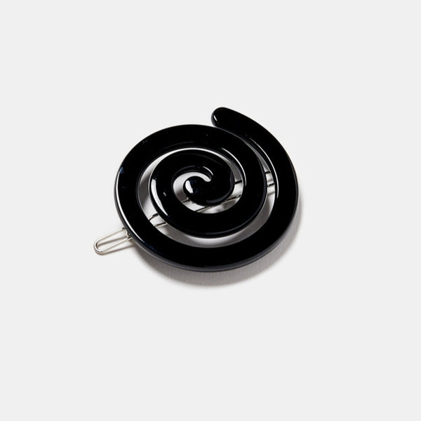 black acetate ball-and-clasp barrette in a rounded spiral shape. Shown flat