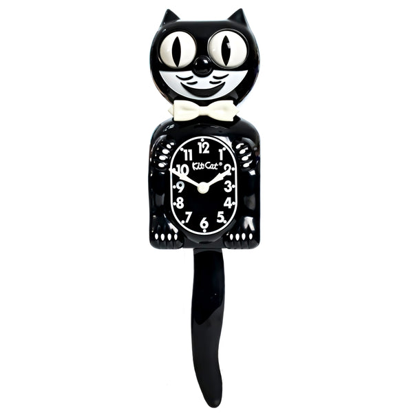 black & white glow in the dark Kit-Cat wall mount clock features a mischievous grin, and big round eyes that swivel side-to-side in time with its pendulum tail. Shown in normal lighting from front
