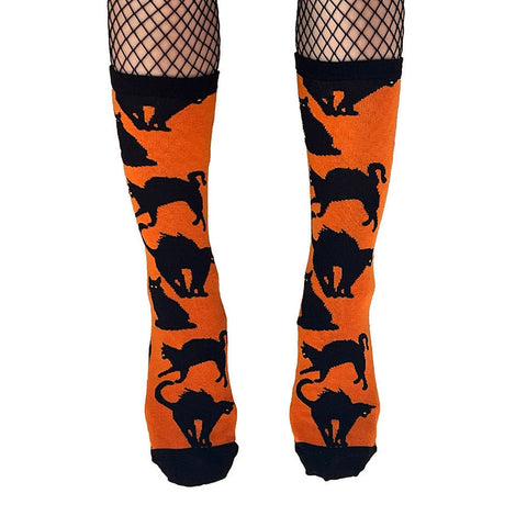 bright orange cotton blend knit unisex crew socks with allover pattern of black cats in various poses with black heels, toes, and cuffs
