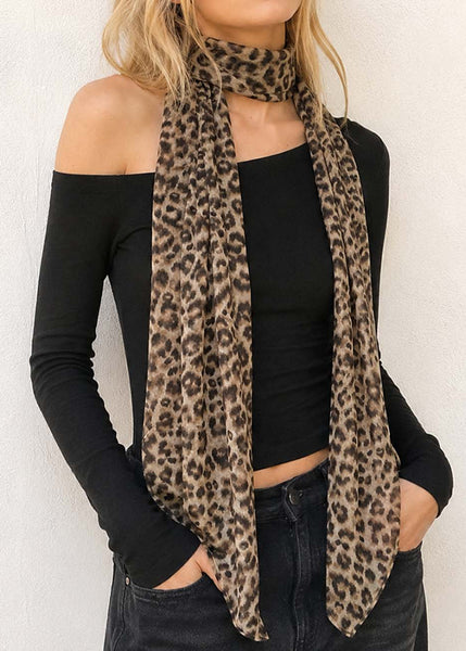 Long rectangular chiffon brown leopard print scarf worn by model around neck