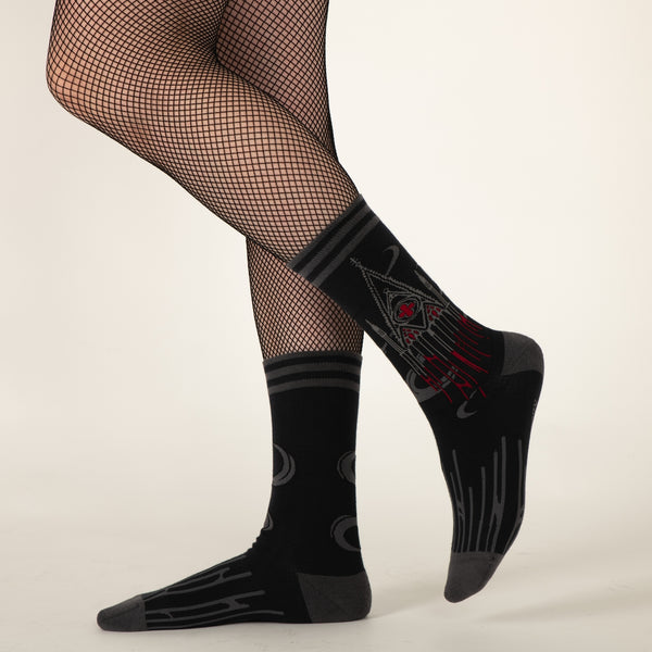 red, black, and grey soft stretch cotton blend crew socks featuring an image of a Gothic style cathedral dripping with red blood, shown on model