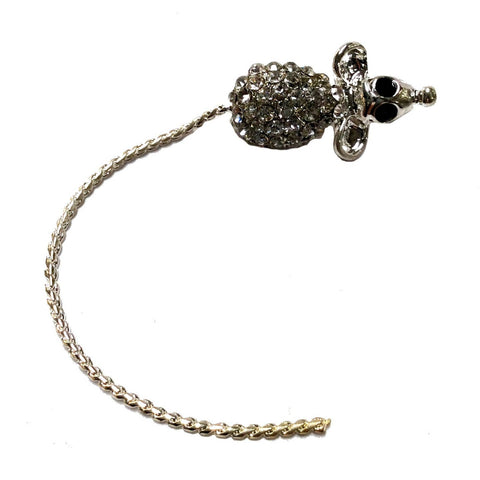 jeweled brooch in the shape of a tiny mouse with clear rhinestoned body, large black eyes, and braided metal tail all in gold metal 
